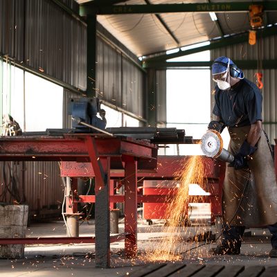 worker grinding steel by industrial photographer ben bergh