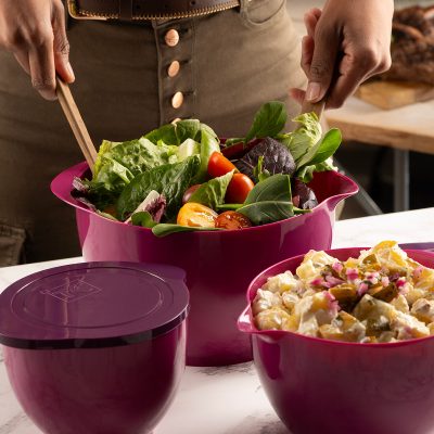 plasticware containers with green salad plus potato salad