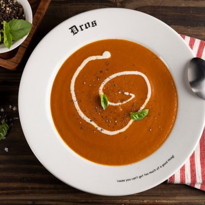 dros tomato soup served with basil and a dollop of cream