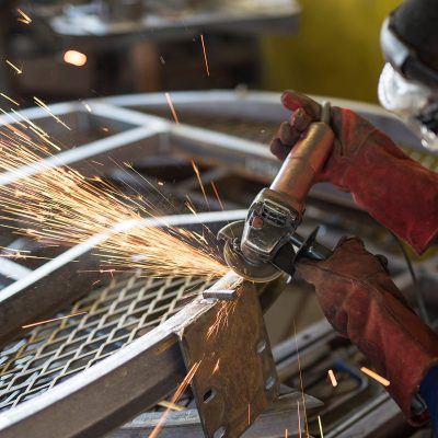 Man doing welding work causing bright sparks