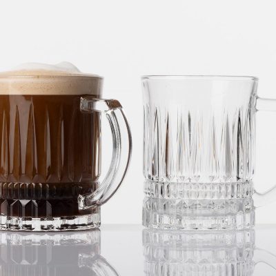 two glassware mugs, one filled with coffee