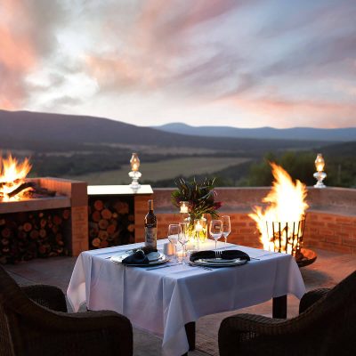 Mooivallie Lodge, Fire and Dinner Setting. Creative Hospitality photography by Ben Bergh Architectural Photography Expert ZA