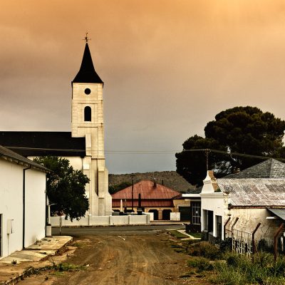Sunrise view of small town and church building in background