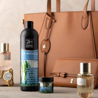styled product group shot containing handbag, fragrances and watch