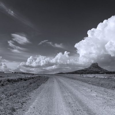 Curving Free State Farm road with dramatic clouds